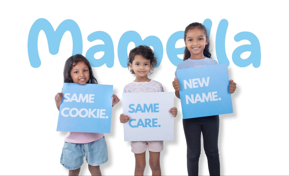 Three young girls standing side by side holding blue and white signs that read 'SAME COOKIE.', 'SAME CARE.